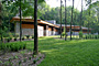 extior view of custom designed  Frank lloyd wright inspired custom home plans by former taliesin fellow house showing cultured stone